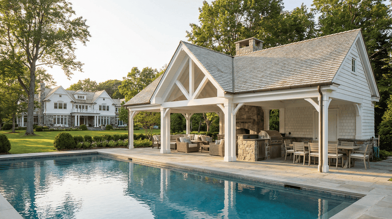 Pavilion by a pool with outdoor furniture and a house in the background
